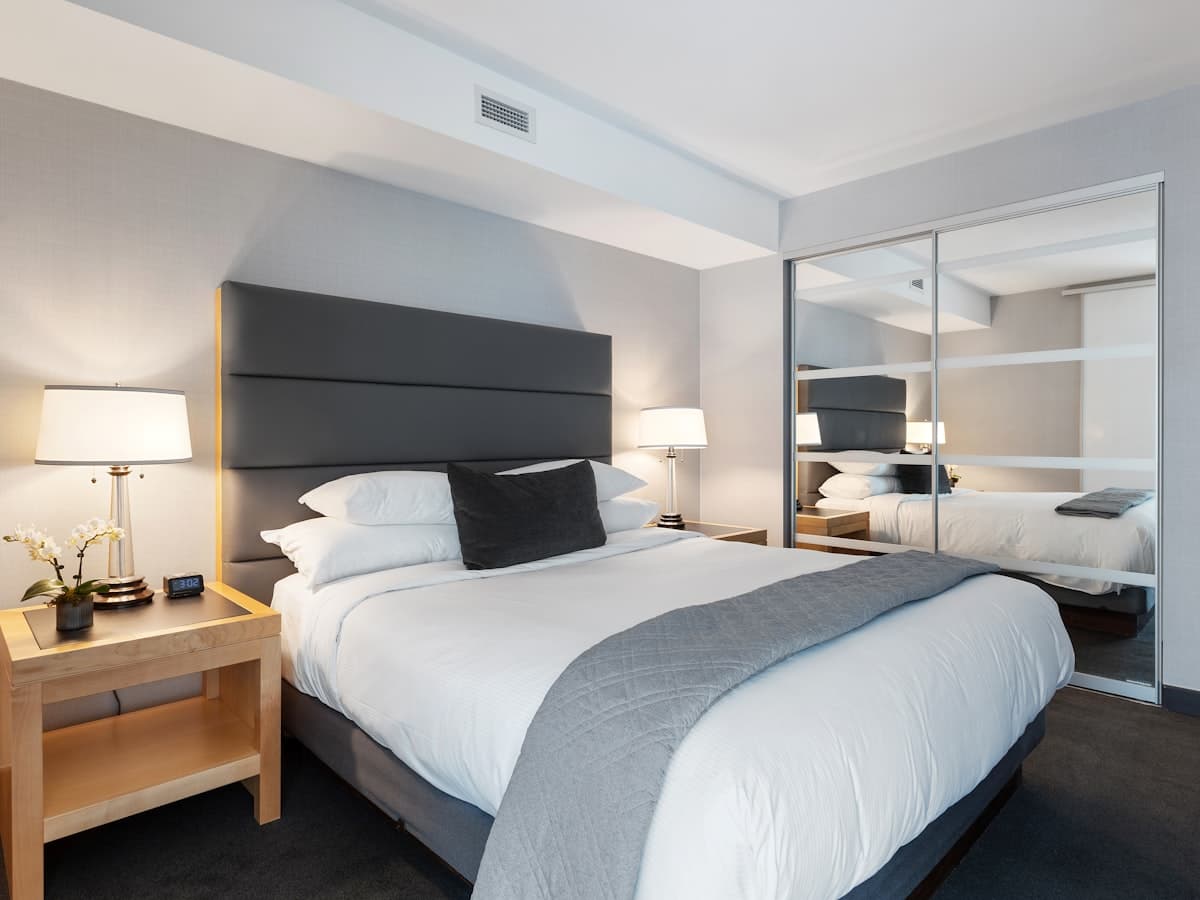 Crisp white layered bedding protected by a fitted mattress protector